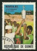 Colnect-1306-951-President-Toure-and-Player-Holding-Cup.jpg